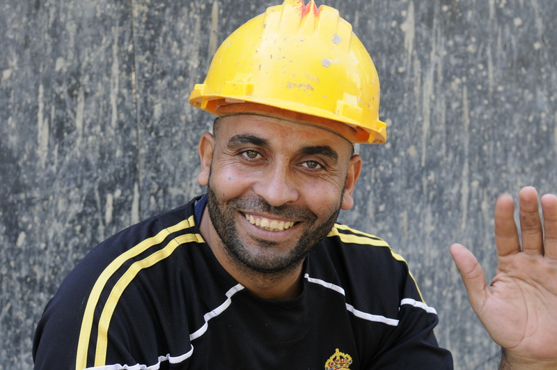 Ouvrier souriant au regard fatiqué